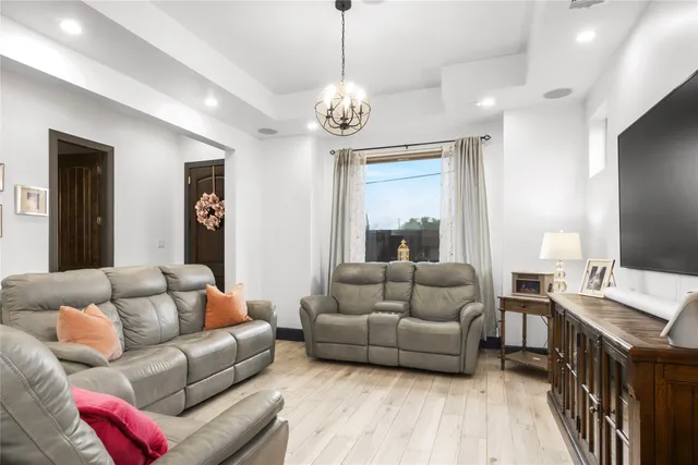 a living room with furniture and a chandelier