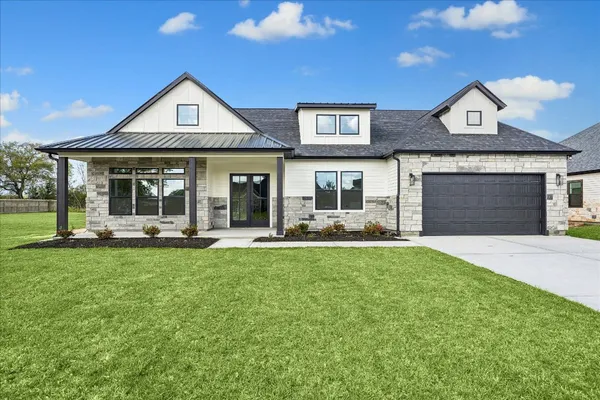 a front view of a house with yard patio and fire pit