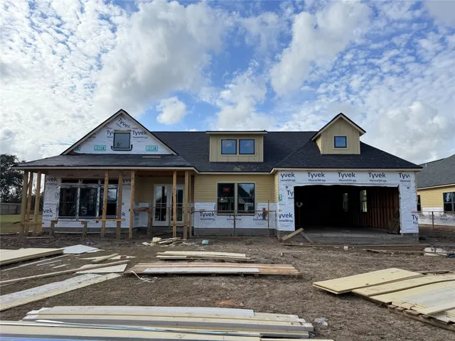 a front view of a house with a garden and parking space