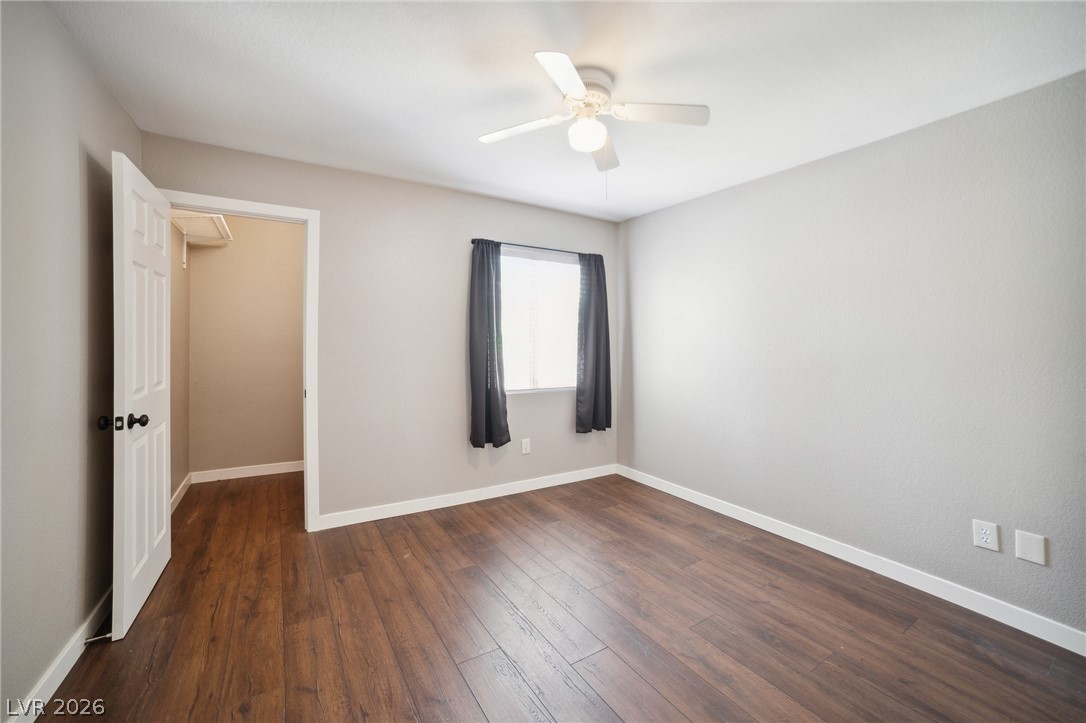 7885 West Flamingo Road, Unit 2041 Las Vegas, NV 89147 - Photo 11 of 14 Unfurnished bedroom featuring a ceiling fan and dark wood-style floors