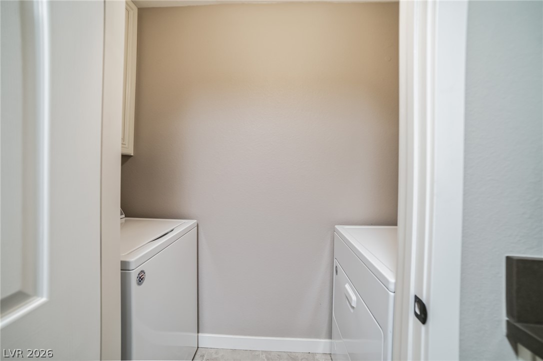 7885 West Flamingo Road, Unit 2041 Las Vegas, NV 89147 - Photo 13 of 14 Laundry area featuring washer and clothes dryer and cabinet space