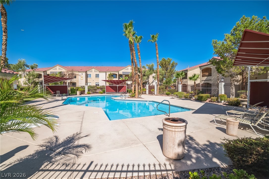 7885 West Flamingo Road, Unit 2041 Las Vegas, NV 89147 - Photo 14 of 14 Community pool featuring a patio, a pergola, and a residential view