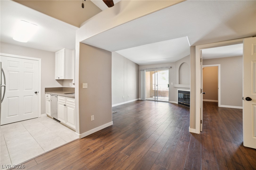 7885 West Flamingo Road, Unit 2041 Las Vegas, NV 89147 - Photo 4 of 14 Kitchen featuring dark wood finished floors, white cabinetry, and light countertops