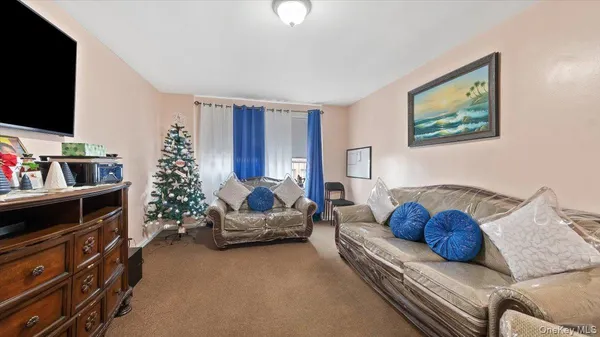 a bedroom with furniture and a flat screen tv