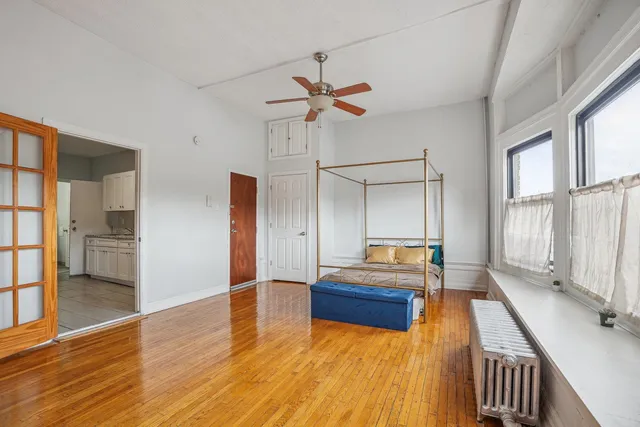 a bedroom with a bed and a chandelier