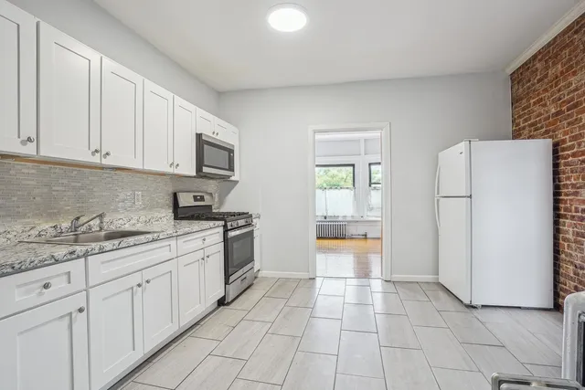a kitchen with stainless steel appliances granite countertop a refrigerator sink and cabinets