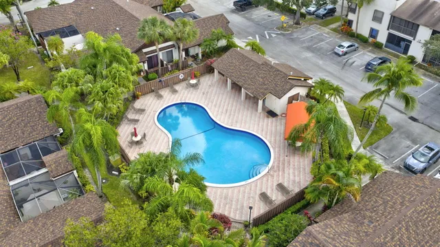 an aerial view of a house with garden space and street view