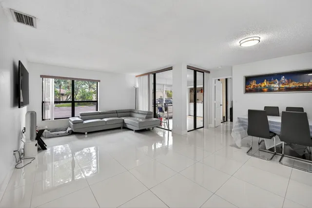 a view of a livingroom with workspace and a window