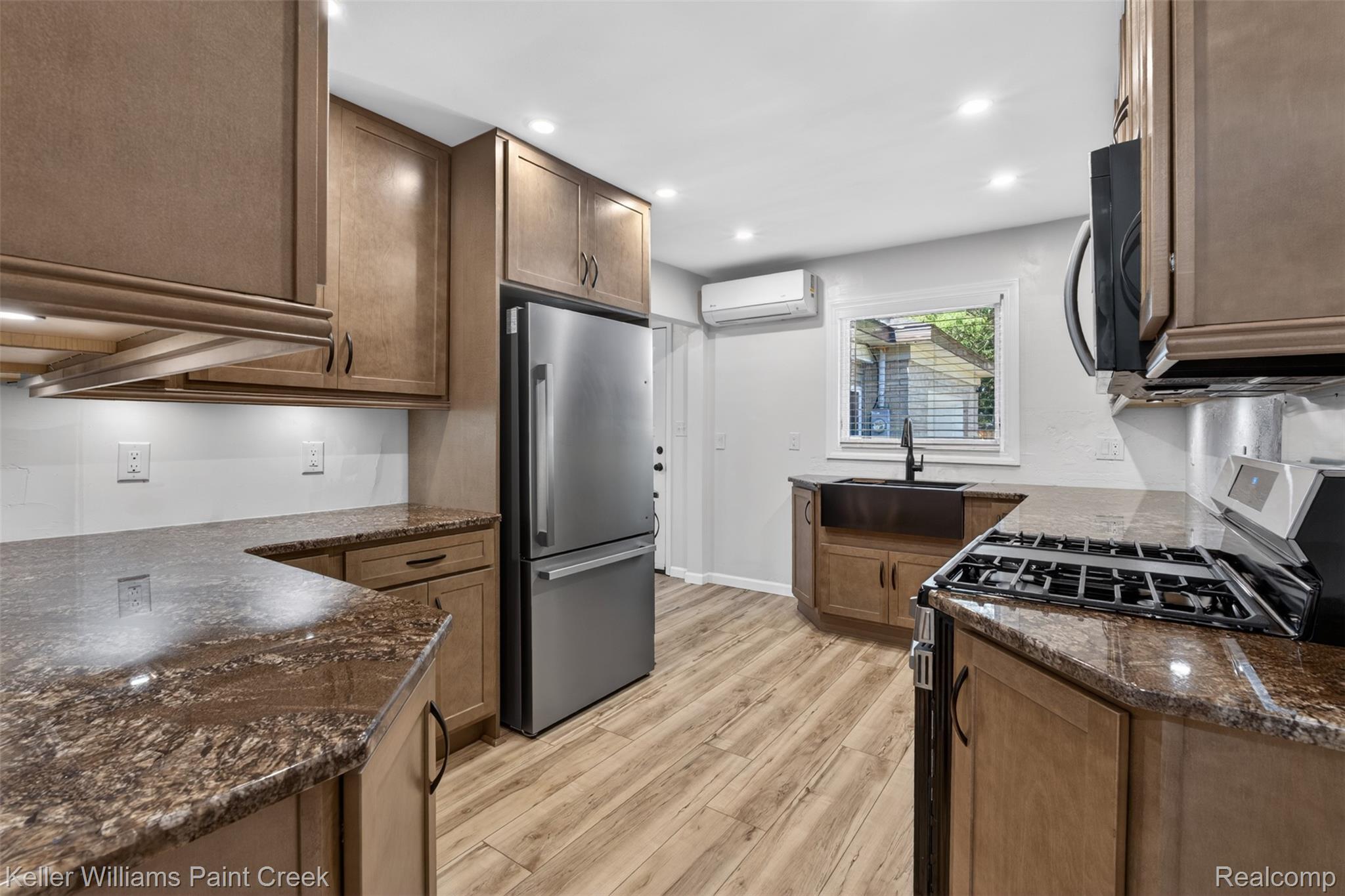 2942 Tatham Road Saginaw, MI 48601 - Photo 2 of 59 Kitchen featuring black appliances, dark stone counters, light wood-type flooring, and recessed lighting