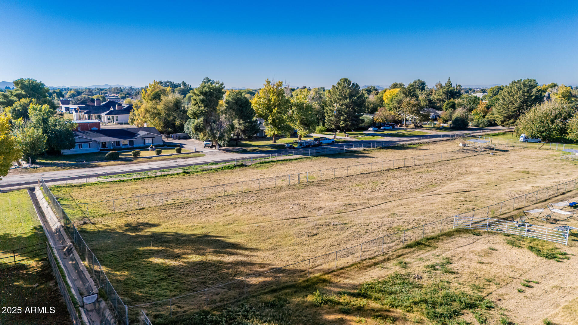 Xxx East Appleby Road Gilbert, AZ 85298 - Photo 4 of 16 a view of swimming pool with outdoor seating and trees in the background