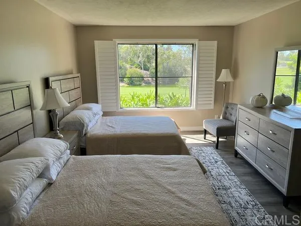 a bedroom with a large bed and a window