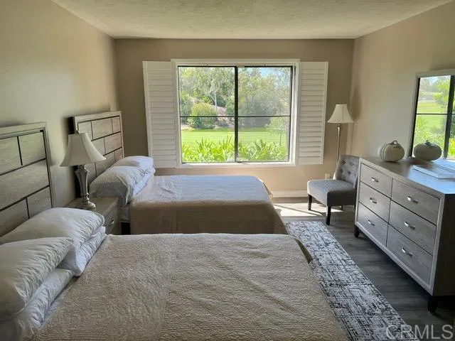 a bedroom with a large bed and a window