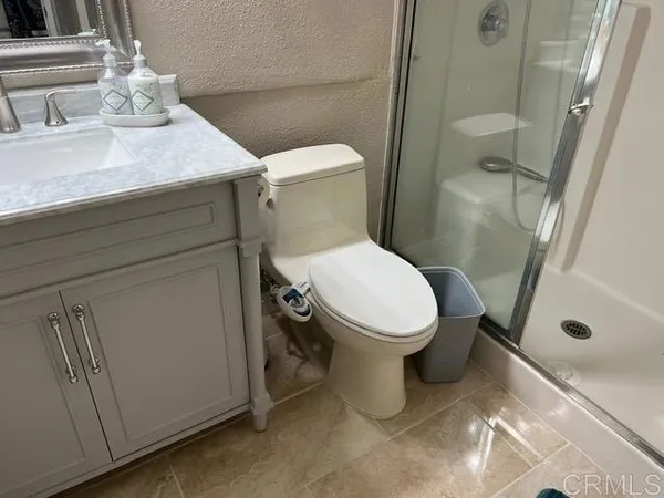 a white toilet sitting next to a bathroom sink