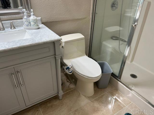 12260 Corte Sabio, Unit 5103 San Diego, CA 92128 - Photo 8 of 10 a white toilet sitting next to a bathroom sink