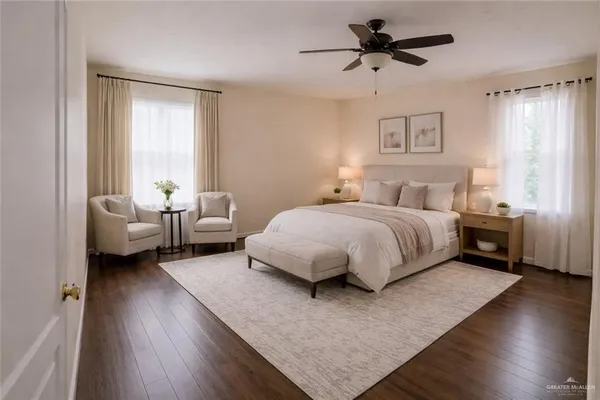 a bedroom with a bed couch and a window