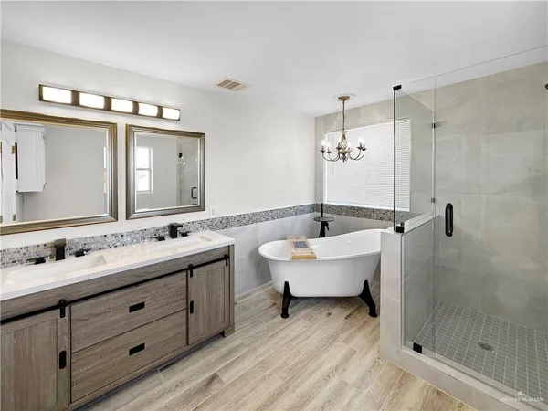 a spacious bathroom with a double vanity sink mirror and double