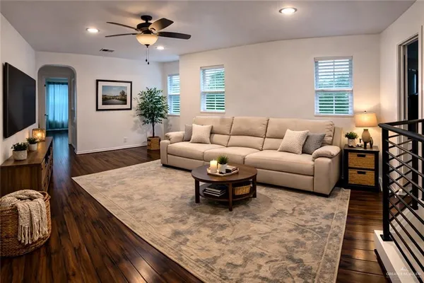 a living room with furniture and a flat screen tv