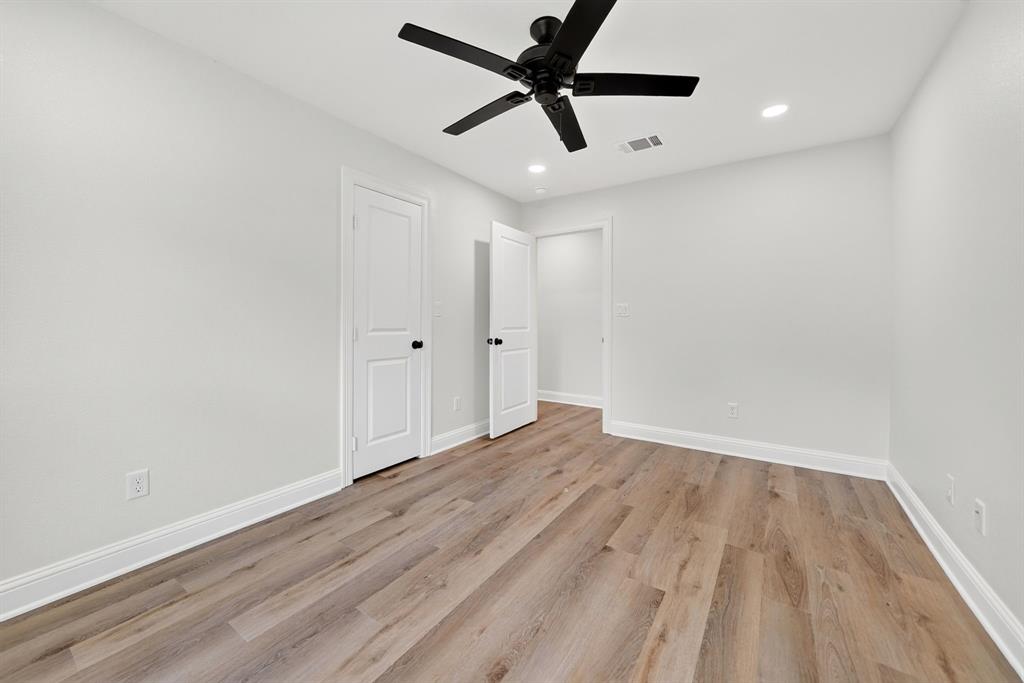 608 Bunny Rabbit Road Athens, TX 75751 - Photo 25 of 33 Spacious room featuring wood-finish flooring, white baseboards, and bright white walls
