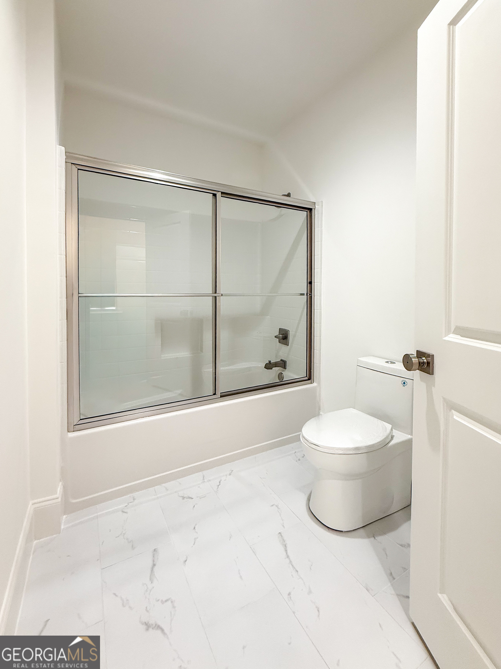 2125 Goat Neck Road Cleveland, GA 30528 - Photo 19 of 24 a bathroom with a shower a toilet and a glass window