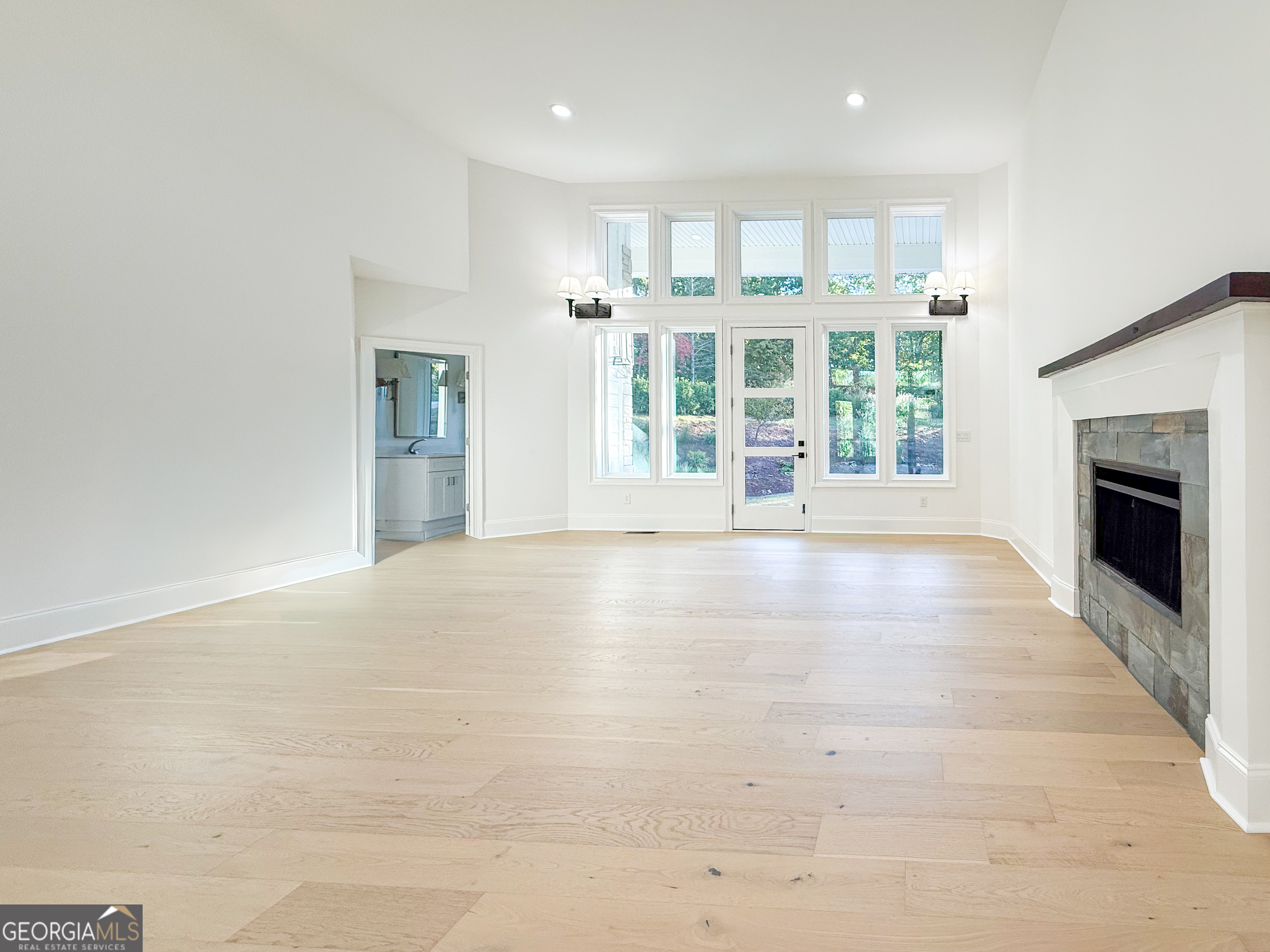 2125 Goat Neck Road Cleveland, GA 30528 - Photo 5 of 24 an empty room with floor to ceiling windows and fireplace
