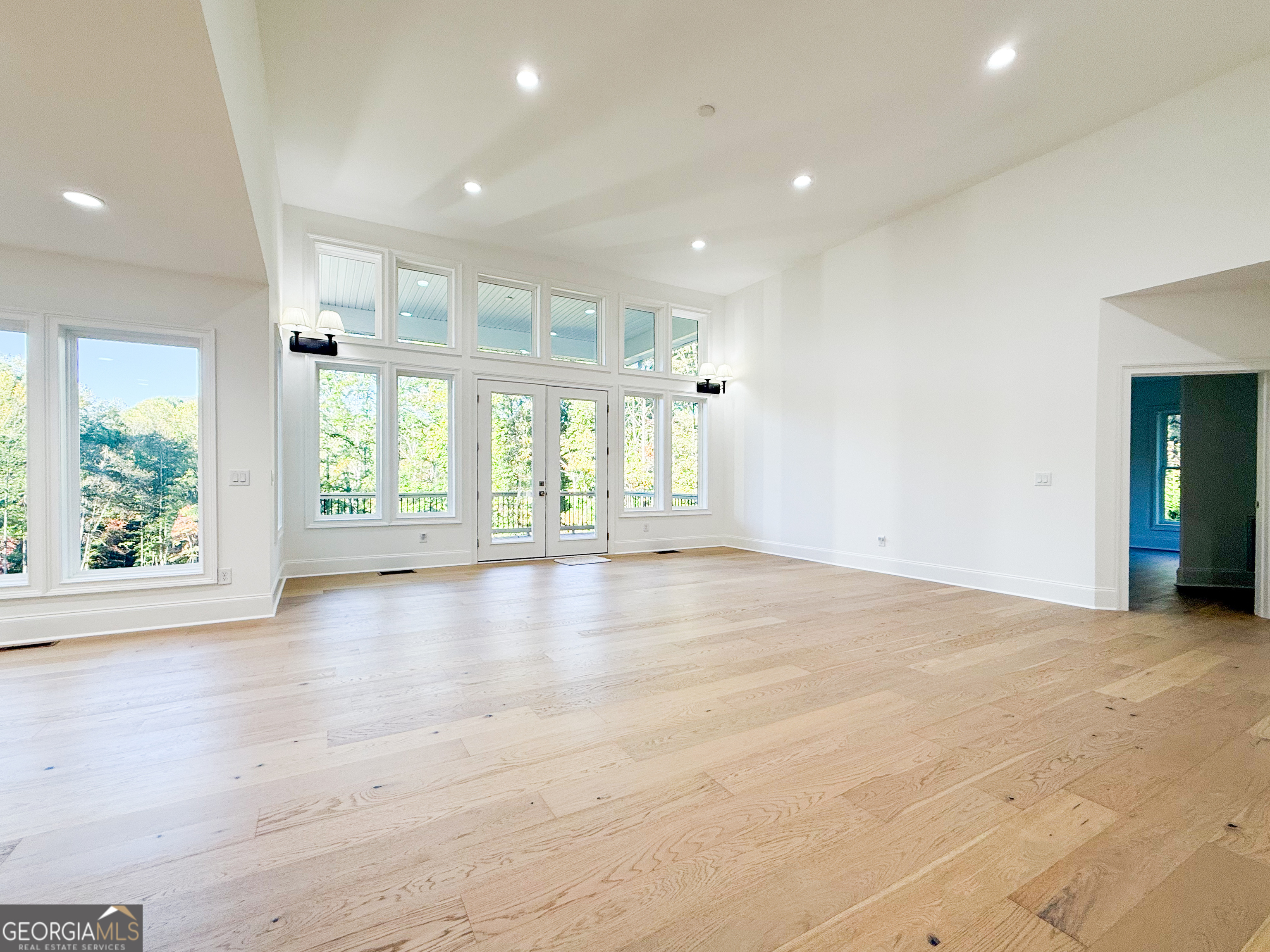 2125 Goat Neck Road Cleveland, GA 30528 - Photo 6 of 24 an empty room with wooden floor and windows