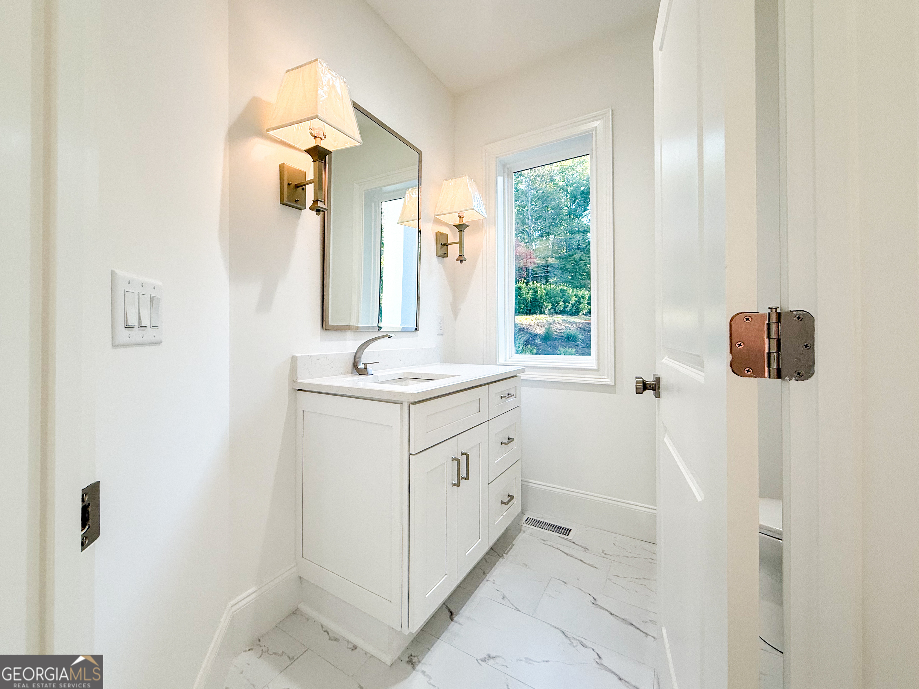 2125 Goat Neck Road Cleveland, GA 30528 - Photo 7 of 24 a bathroom with a double vanity sink window and mirror