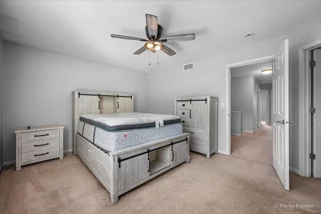 a room with a baby bed dresser and a window