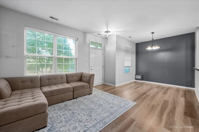 a living room with furniture and a large window