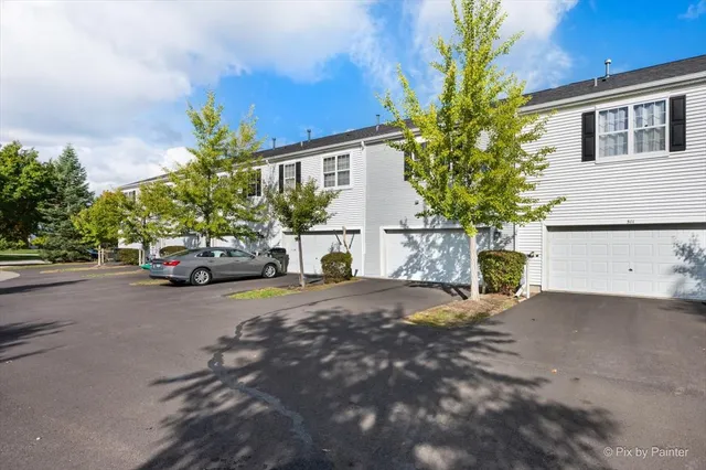 a view of a house with a yard and garage