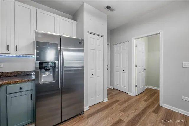 a kitchen with a refrigerator and a refrigerator