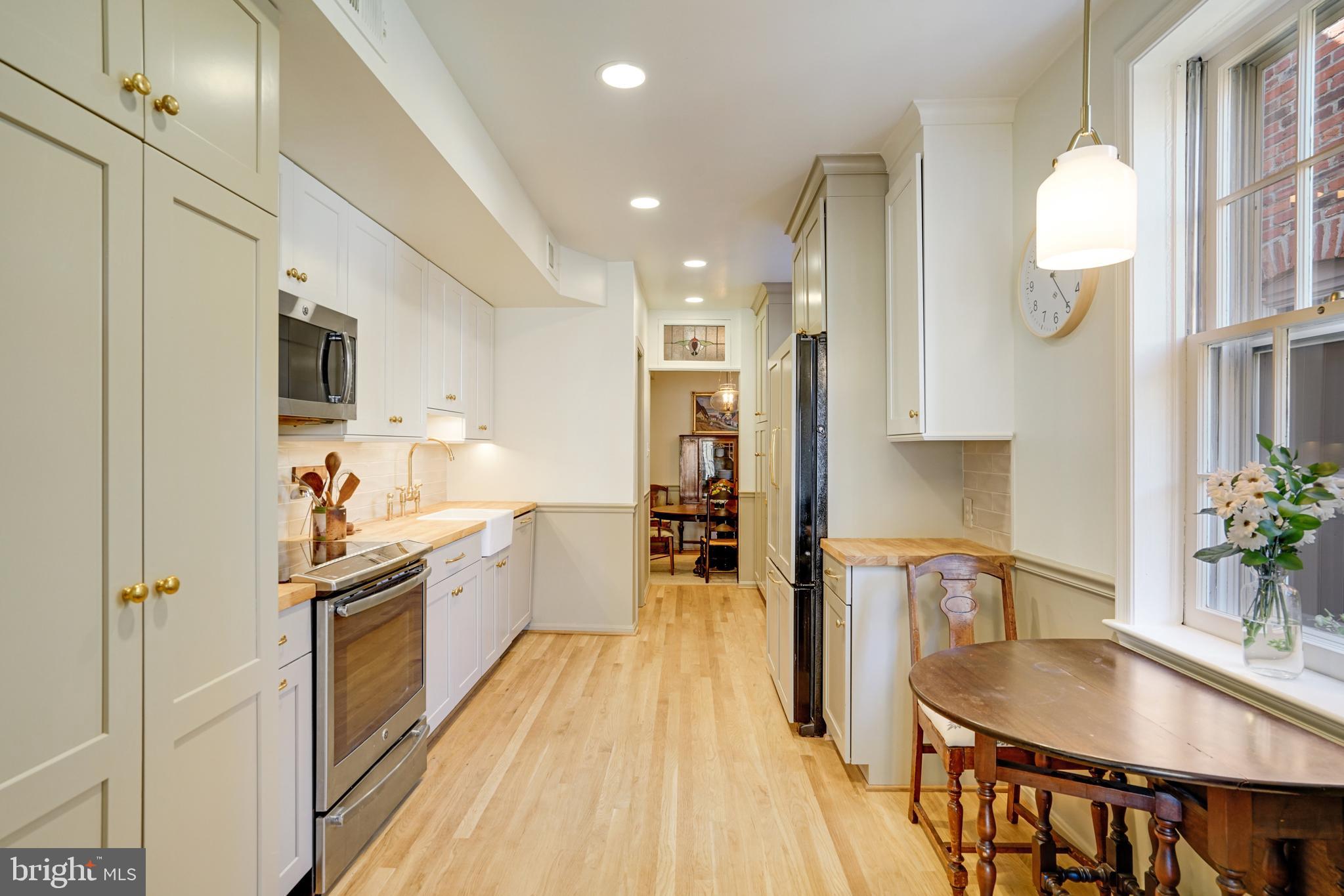817 Duke Street Alexandria, VA 22314 - Photo 13 of 39 a kitchen with kitchen island granite countertop lots of counter top space and stainless steel appliances