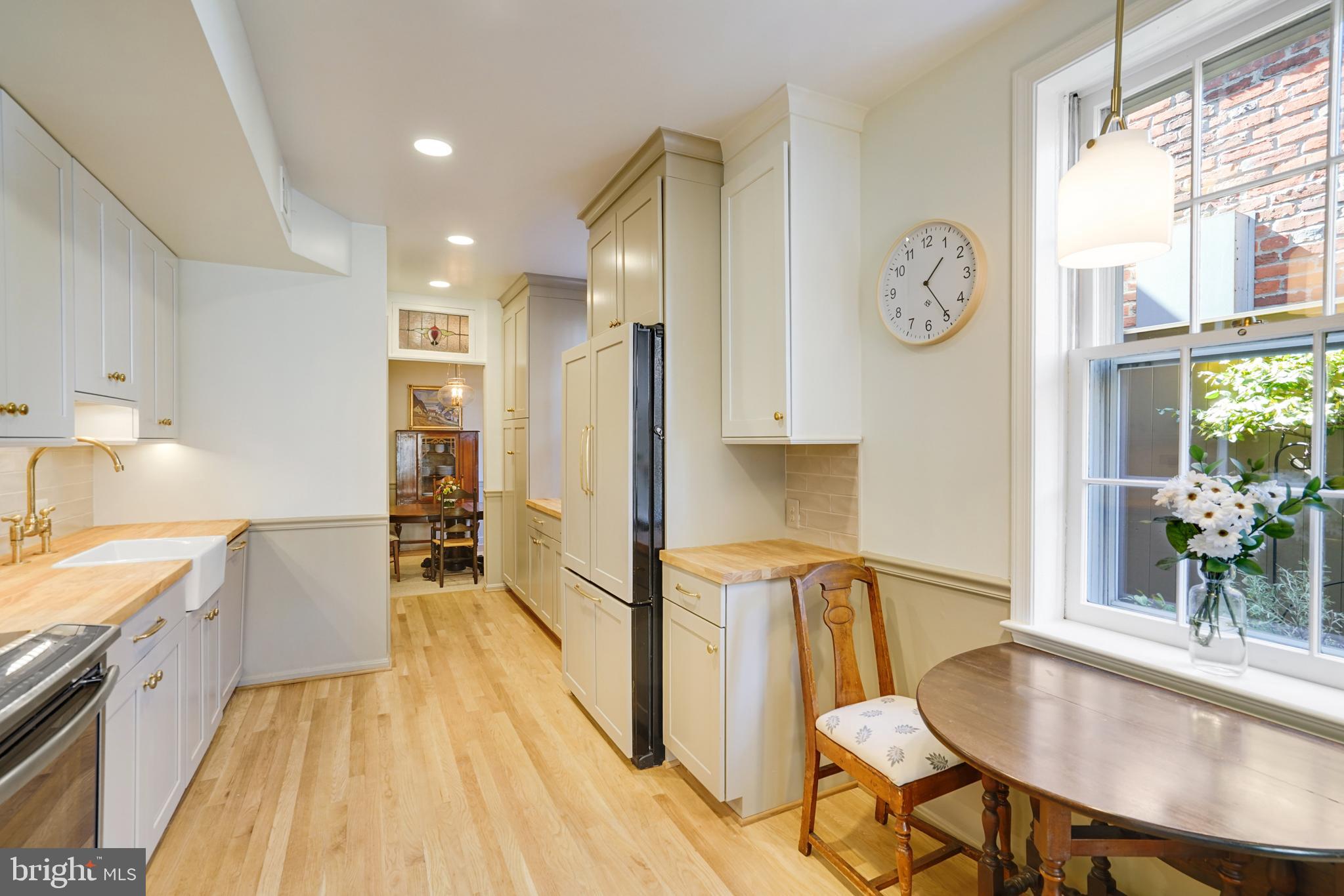 817 Duke Street Alexandria, VA 22314 - Photo 17 of 39 a living room with stainless steel appliances furniture a large window and a kitchen view