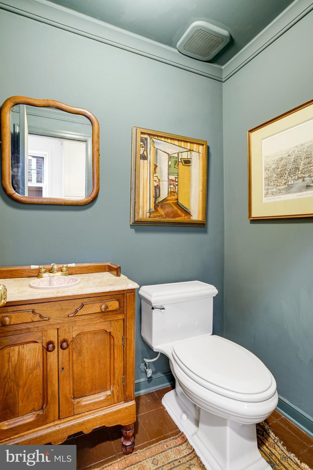 817 Duke Street Alexandria, VA 22314 - Photo 21 of 39 a bathroom with a toilet a sink and mirror