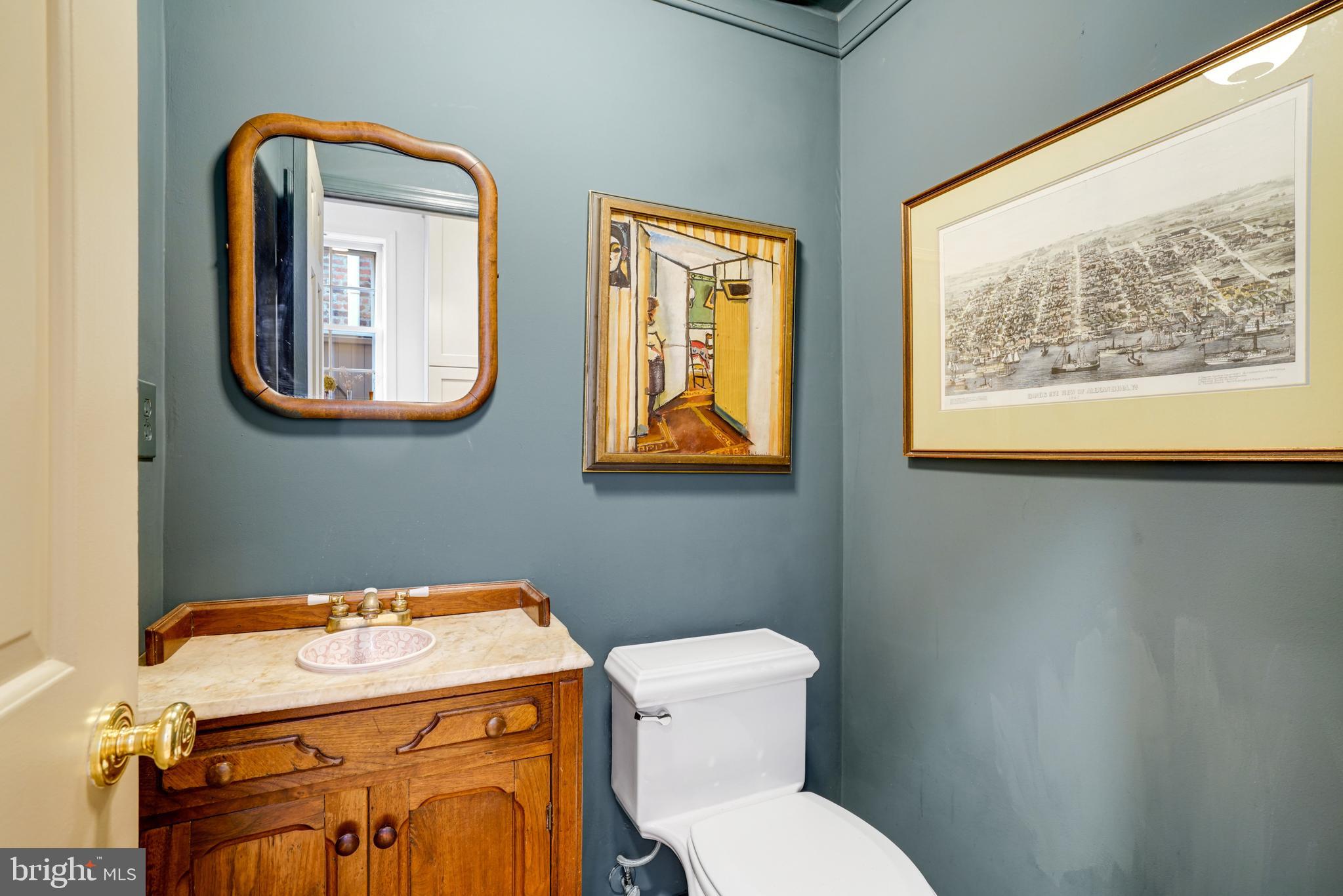 817 Duke Street Alexandria, VA 22314 - Photo 22 of 39 a bathroom with a toilet sink and mirror
