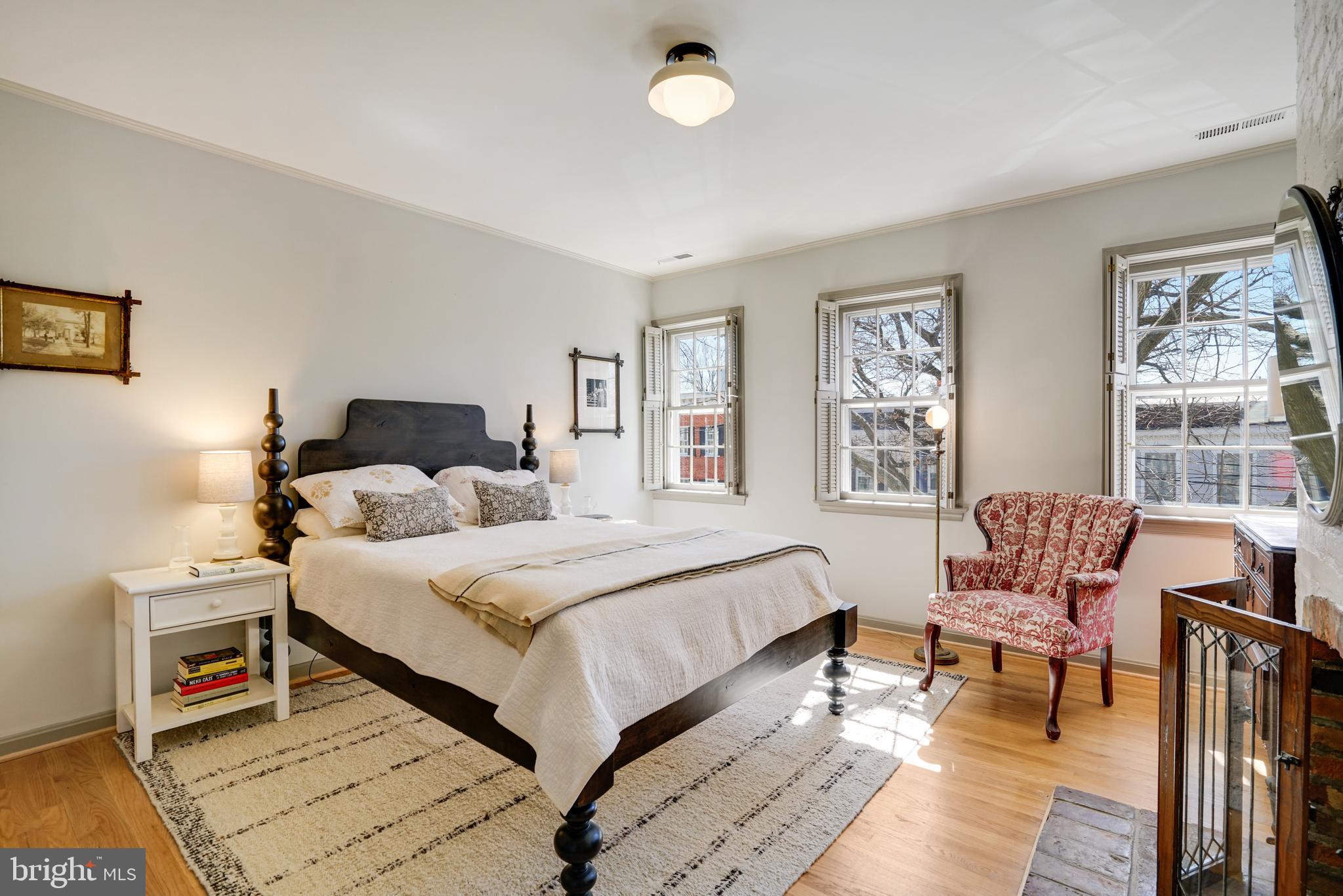 817 Duke Street Alexandria, VA 22314 - Photo 23 of 39 a bedroom with a bed and wooden floor