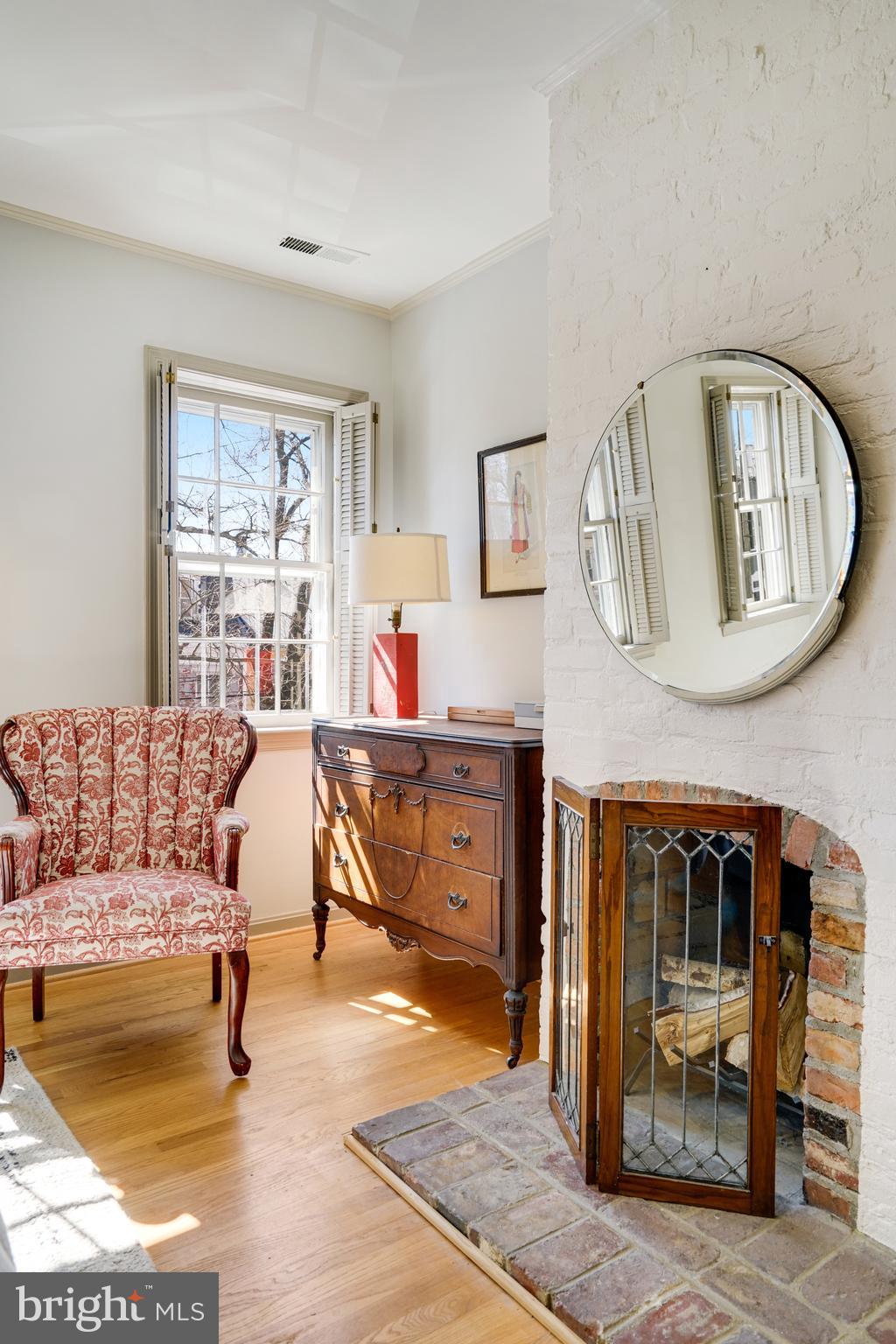 817 Duke Street Alexandria, VA 22314 - Photo 25 of 39 a living room with furniture and a fireplace