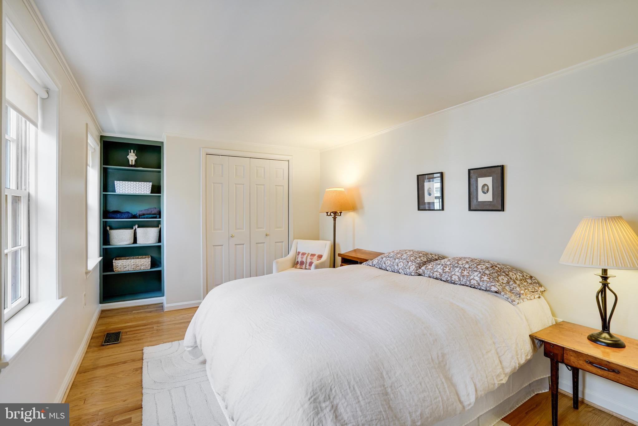 817 Duke Street Alexandria, VA 22314 - Photo 29 of 39 a spacious bedroom with a bed and a table in it