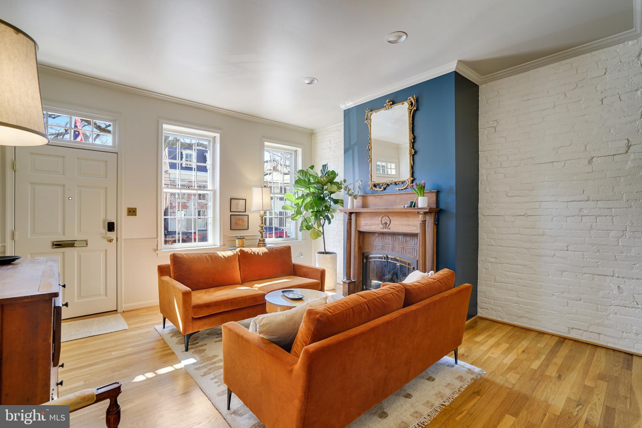817 Duke Street Alexandria, VA 22314 - Photo 3 of 39 a living room with furniture and a fireplace