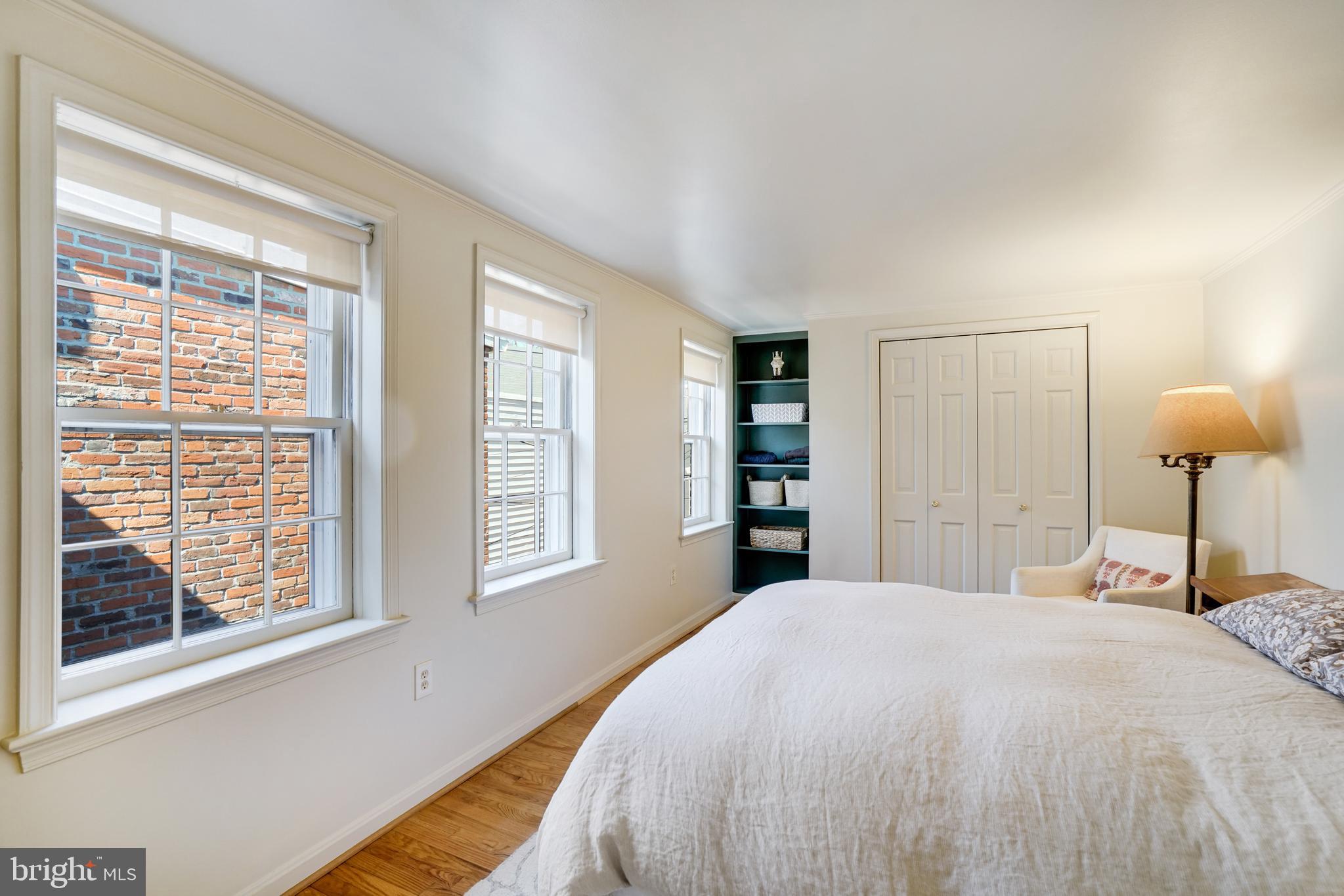 817 Duke Street Alexandria, VA 22314 - Photo 32 of 39 a bedroom with a bed and a window