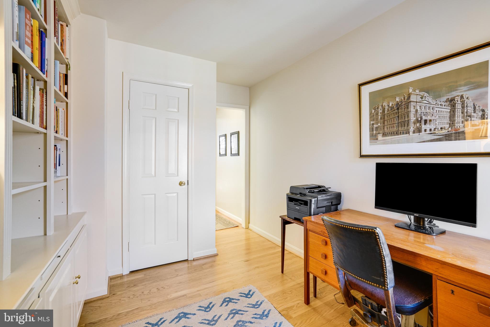 817 Duke Street Alexandria, VA 22314 - Photo 33 of 39 a view of a workspace with furniture and a flat screen tv