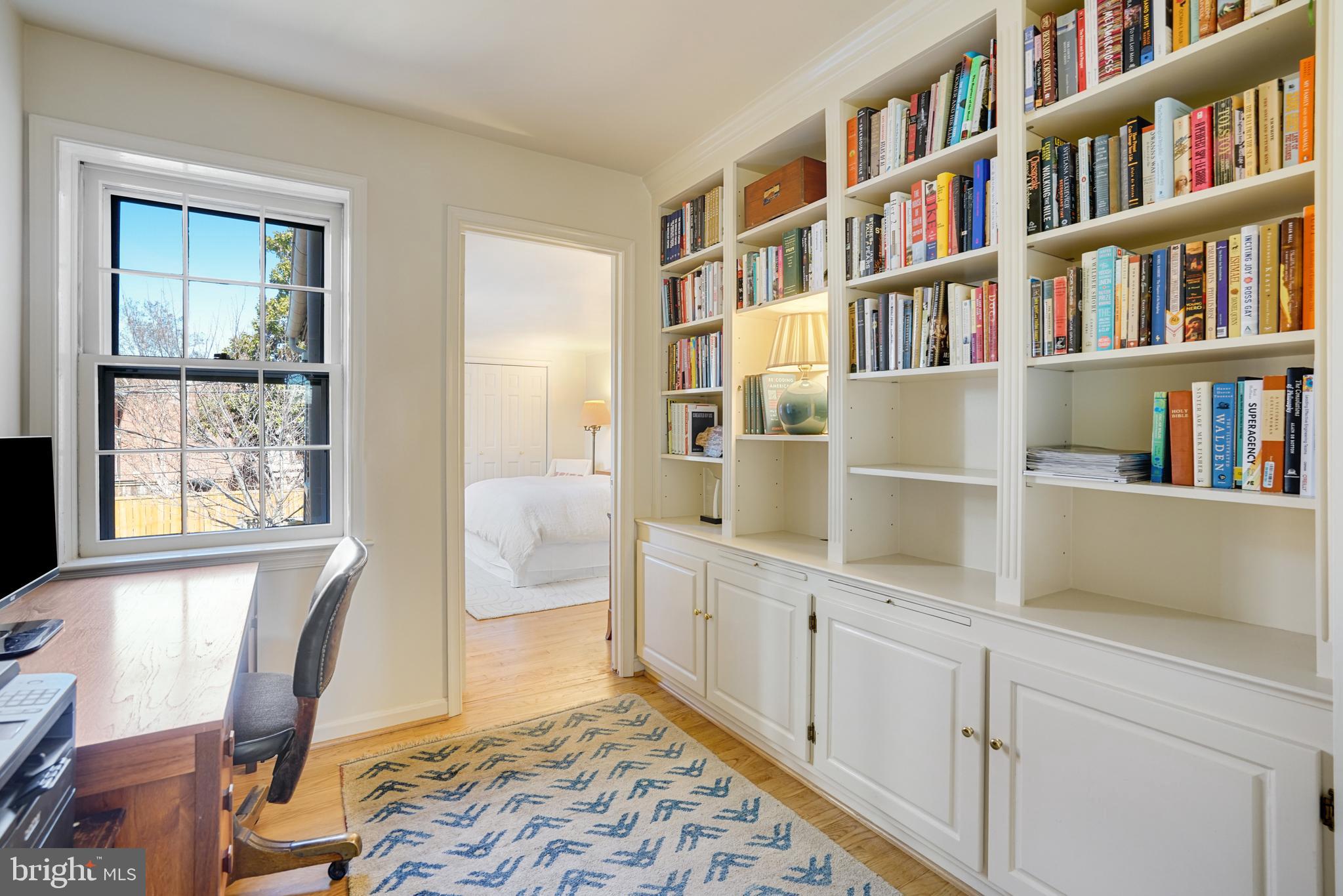 817 Duke Street Alexandria, VA 22314 - Photo 35 of 39 a workspace with furniture and a book shelf