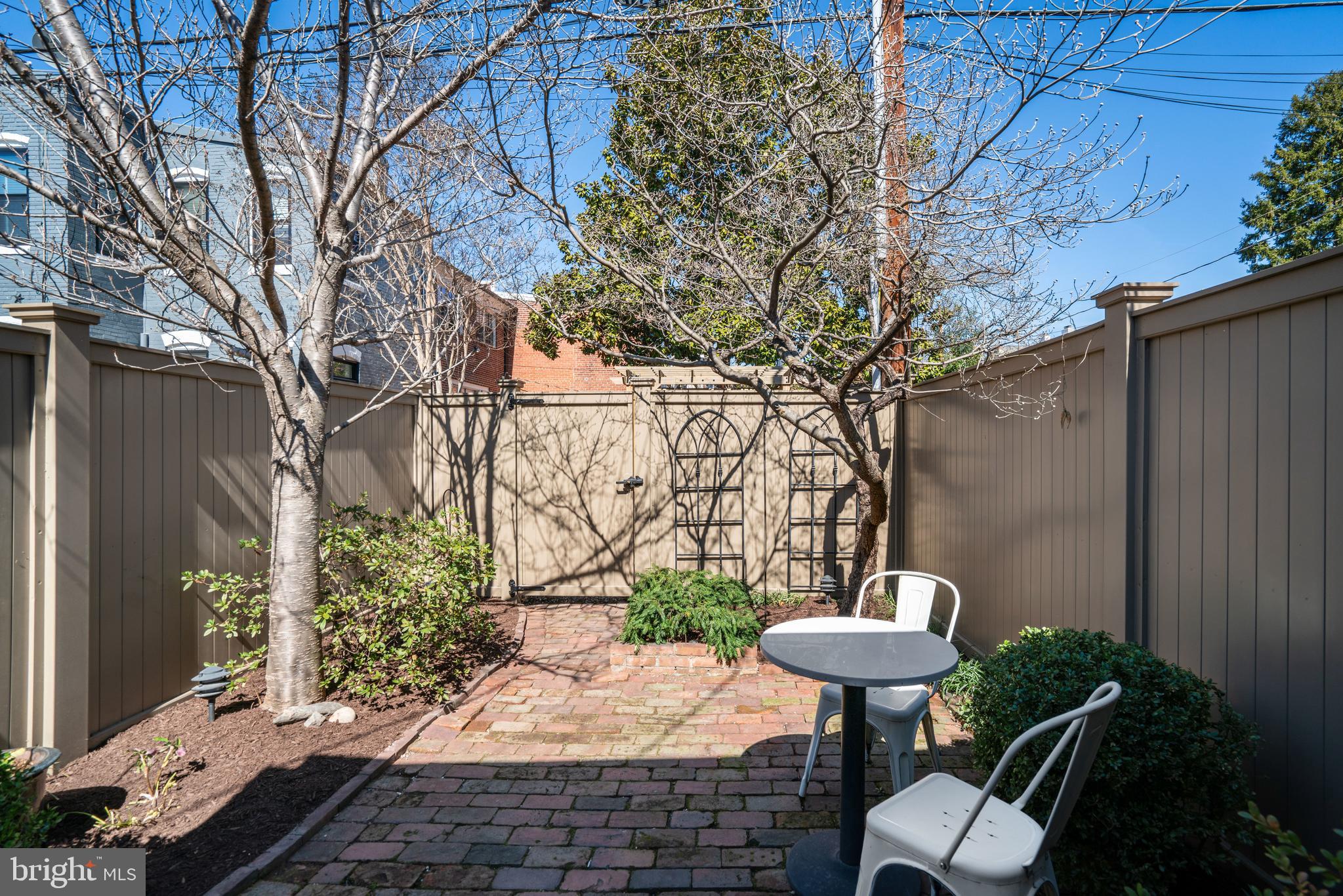 817 Duke Street Alexandria, VA 22314 - Photo 36 of 39 a view of a backyard with table and chairs and a barbeque