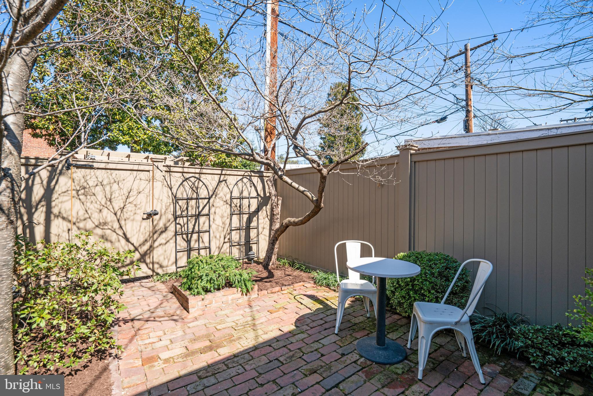817 Duke Street Alexandria, VA 22314 - Photo 37 of 39 a patio with table and chairs and potted plants