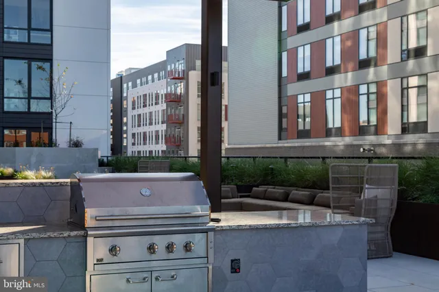 a view of a swimming pool with couches and lounge chairs