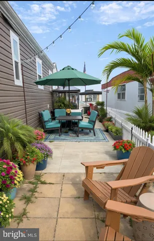 a view of a patio with table and chairs under an umbrella
