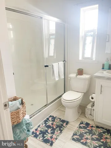 a bathroom with a toilet a sink and a shower