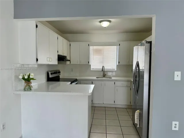 a kitchen with appliances cabinets and a sink