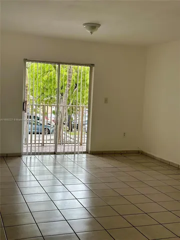 a view of an empty room with a floor to ceiling window
