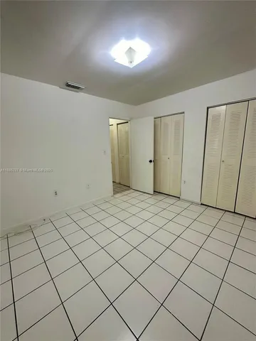 a view of an empty room and a window