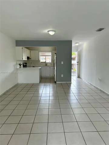 a kitchen with stainless steel appliances a sink cabinets and wooden floor